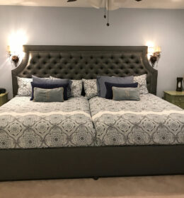 A Double Cushioned Bed With Throw Pillows