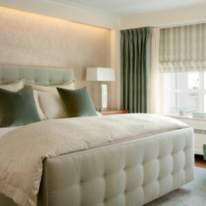 A Cream Color Cushion Lining Bed With Throw Pillows