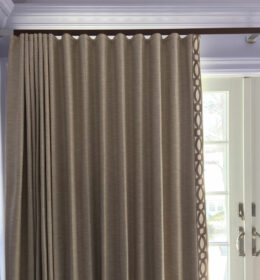A Cream Color Curtain on a Curtain Rod to a Door