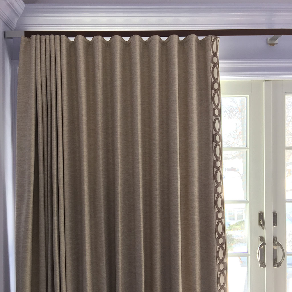 A Cream Color Curtain on a Curtain Rod to a Door