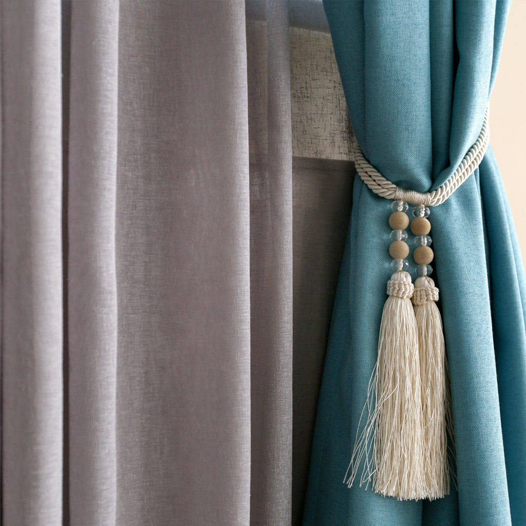 A White Color Curtain Rope With Tassels Hanging
