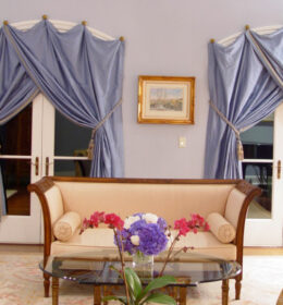 A Livingroom With Powder Blue Satin Curtains
